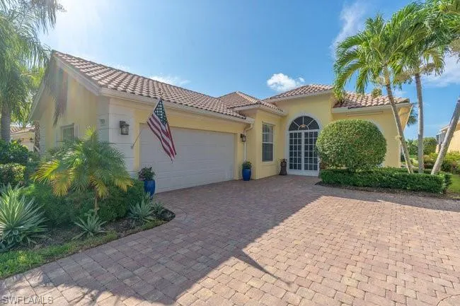 Mediterranean / spanish-style home with a garage