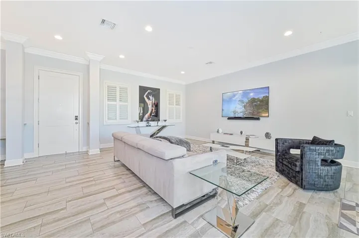 Living room featuring light hardwood / wood-style floors and ornamental molding