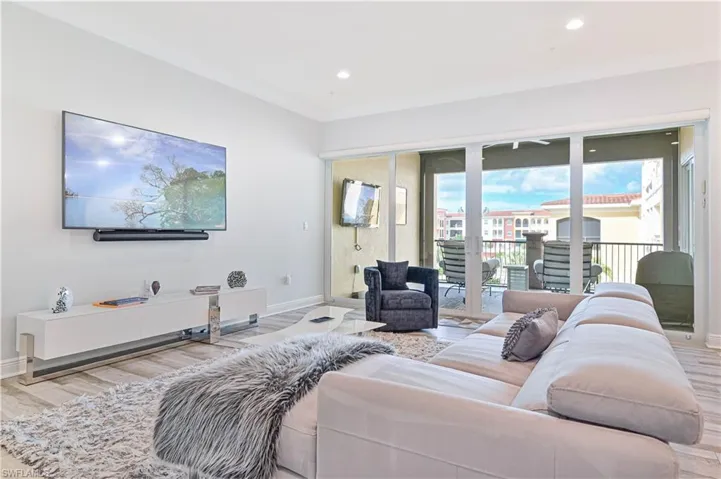 Living room featuring light hardwood / wood-style floors and ornamental molding