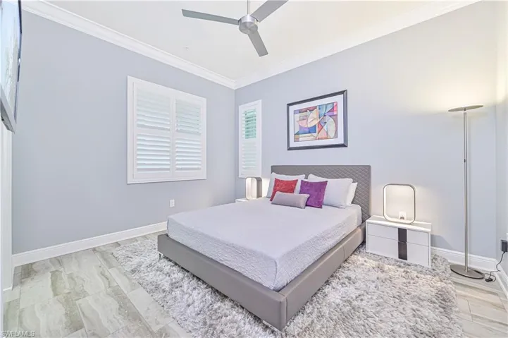 Bedroom with ornamental molding and ceiling fan
