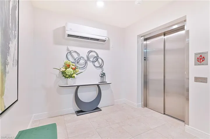 Bathroom featuring a wall mounted air conditioner and elevator