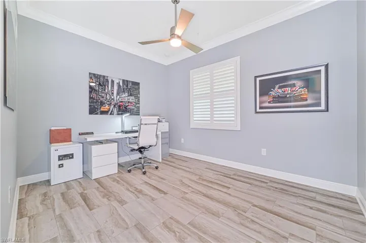 Office space with ceiling fan and crown molding