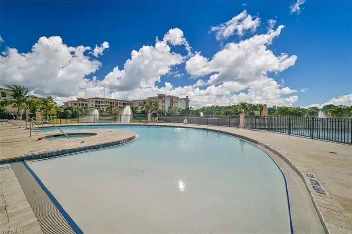 View of outdoor pool with a community hot tub and a patio