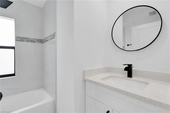 Bathroom featuring vanity and shower / tub combination