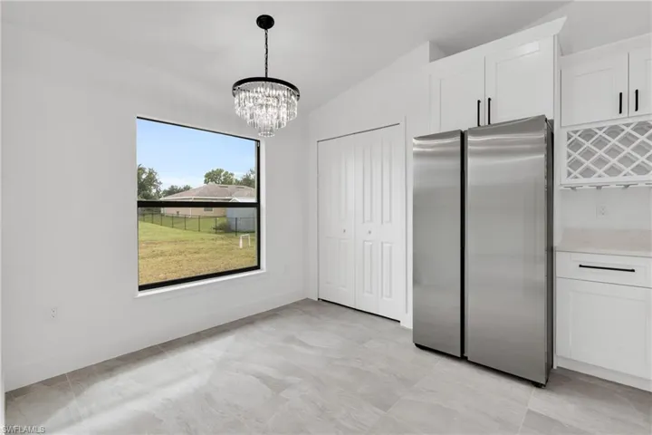 Unfurnished dining area with lofted ceiling and a chandelier