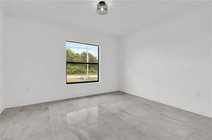 Empty room featuring baseboards