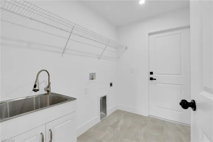 Washroom with hookup for a washing machine and hookup for an electric dryer