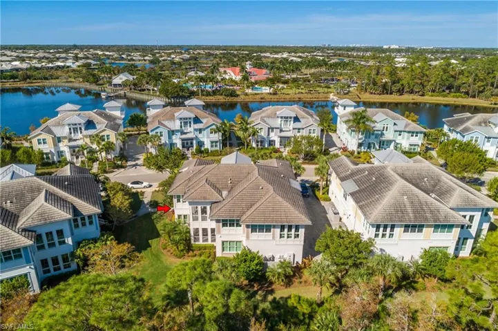 Aerial view of residential area featuring a large body of water
