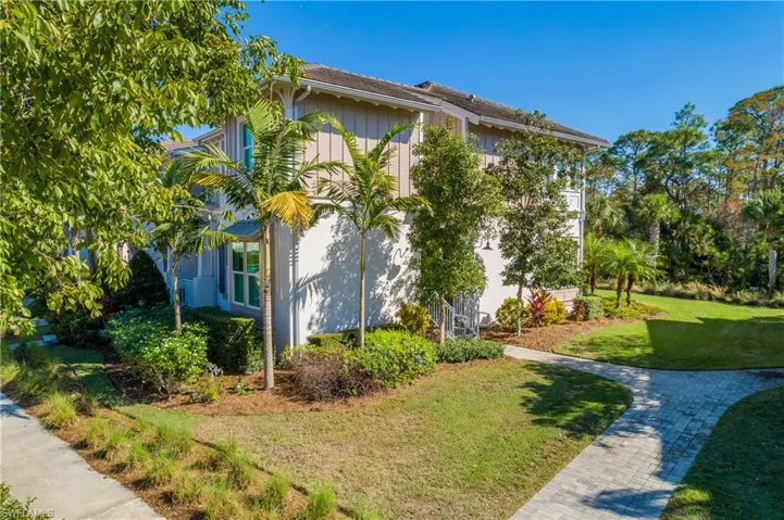 View of side of property featuring a lawn