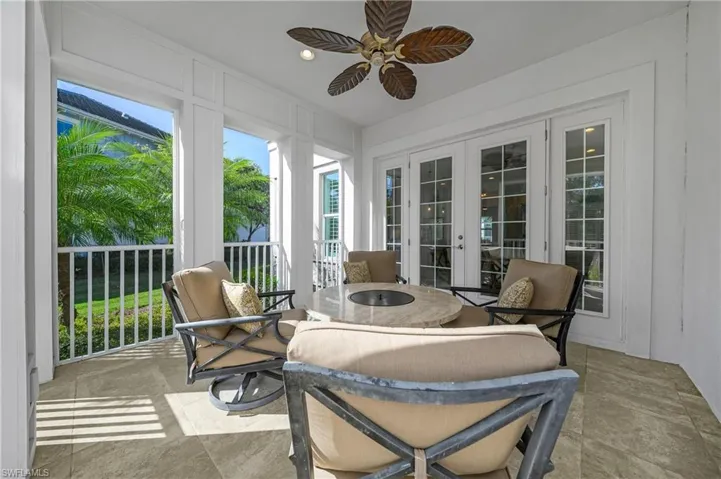 Sunroom featuring french doors and ceiling fan
