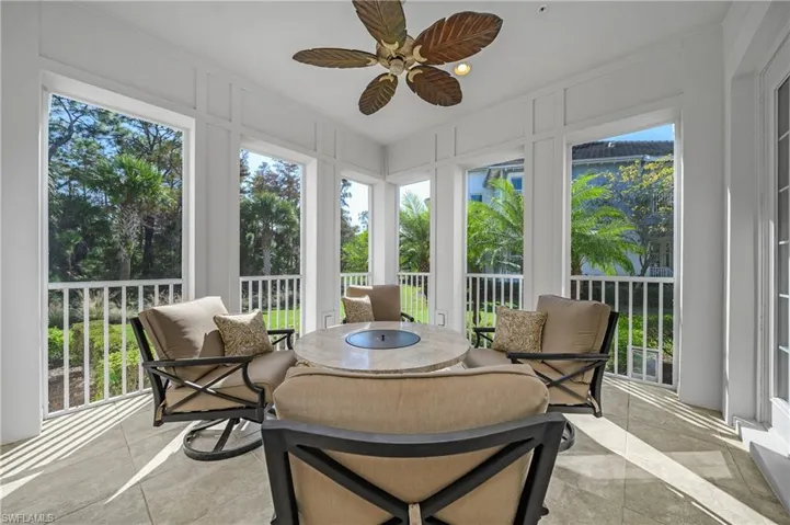 Sunroom featuring ceiling fan and outdoor dining space