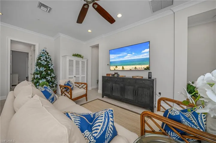 Living area with crown molding, ceiling fan, and recessed lighting