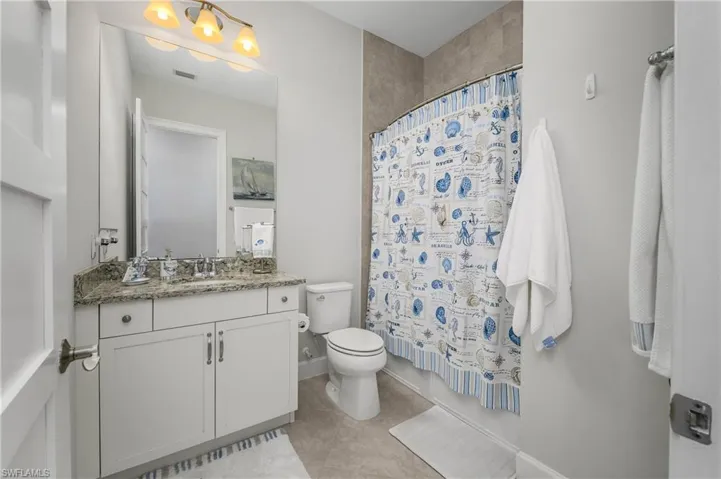 Bathroom featuring vanity and light tile patterned floors