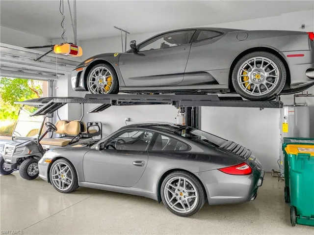 Garage featuring water heater and a garage door opener