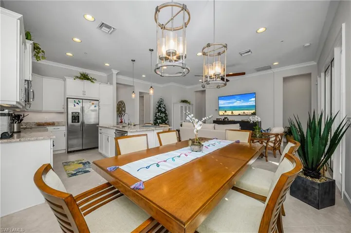 Dining room featuring ornamental molding, recessed lighting, and a chandelier
