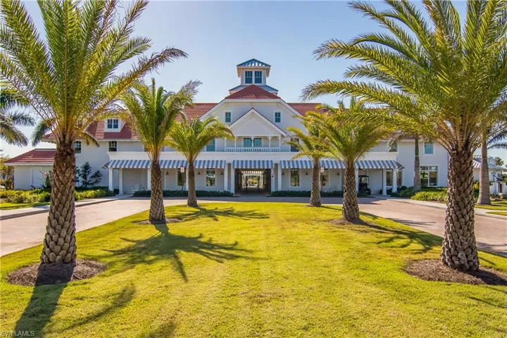 View of front of home featuring curved driveway, a front lawn, and a tile roof