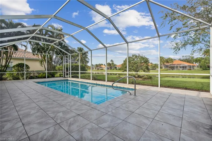View of swimming pool with a lanai, a patio area, and a yard