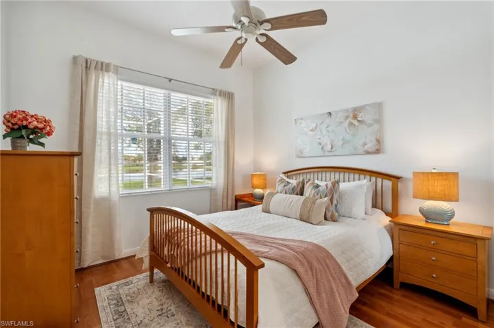 Bedroom featuring ceiling fan and hardwood / wood-style flooring