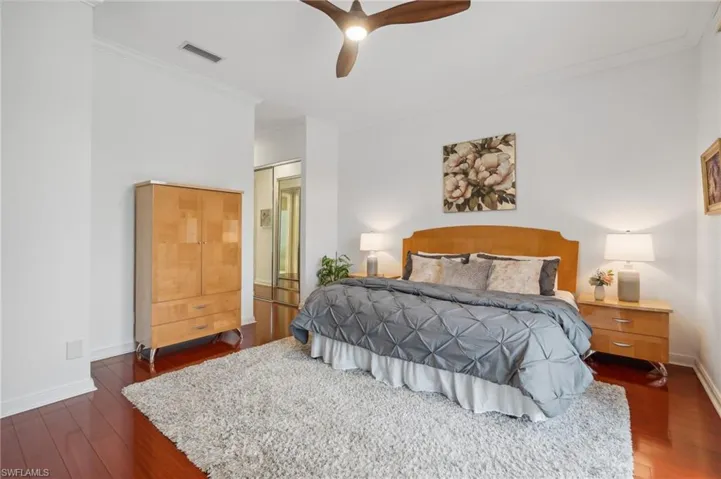 Bedroom featuring crown molding, ceiling fan, and dark wood-type flooring