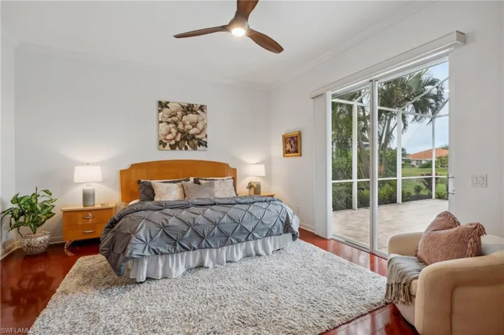 Bedroom featuring ceiling fan, dark hardwood / wood-style floors, access to exterior, and crown molding