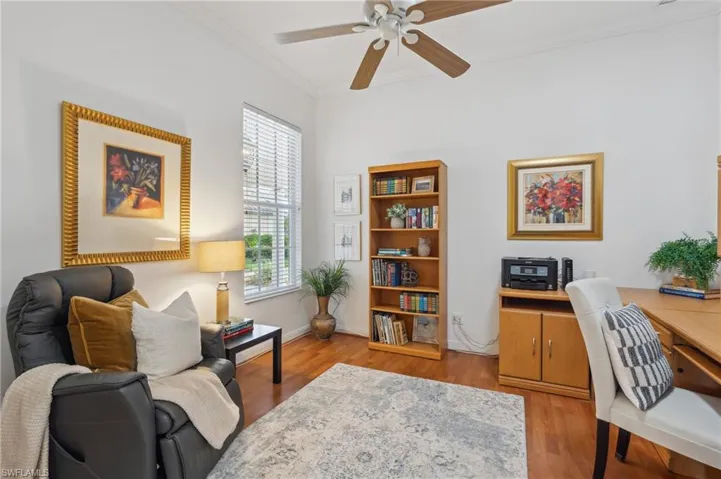 Office space with a wealth of natural light, crown molding, ceiling fan, and light hardwood / wood-style floors
