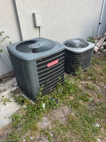 Exterior view of a central AC unit and stucco siding