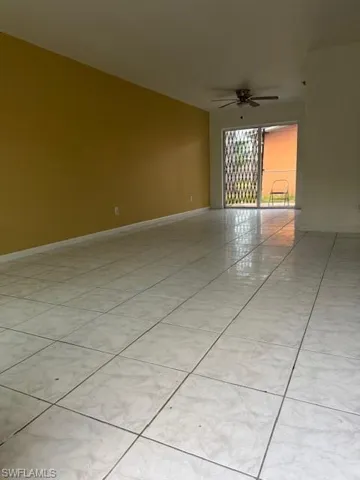 Unfurnished room featuring light tile patterned floors and a ceiling fan