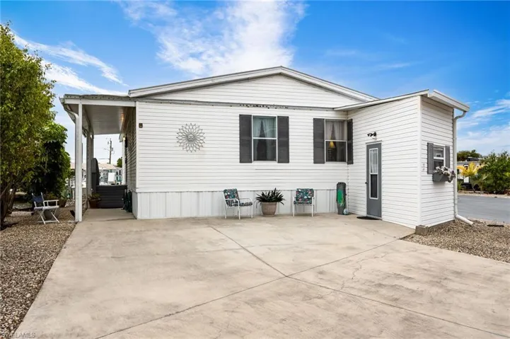 View of home from street showing driveway parking