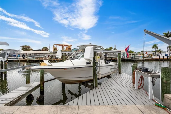 Syntactic boat dock featuring boat lift and a water view