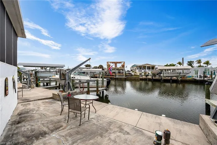 Patio featuring boat lift and view across canal