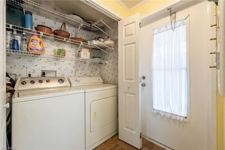 Laundry area featuring washer and dryer and shelving