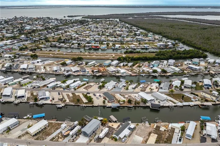 Aerial view of property and surrounding area looking south