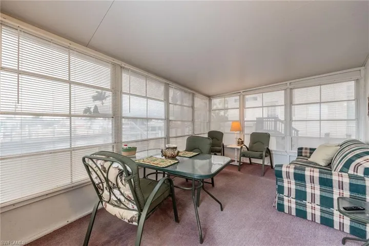 Sunroom featuring a view of the canal and lots of natural light