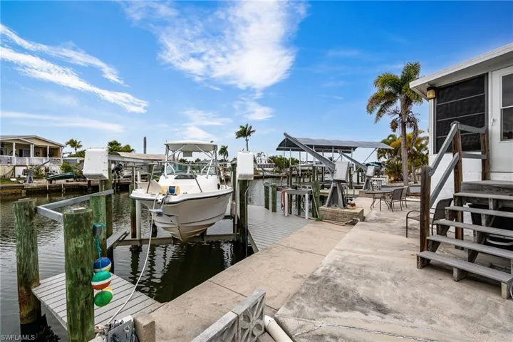 Dock area featuring boat lift and a water view