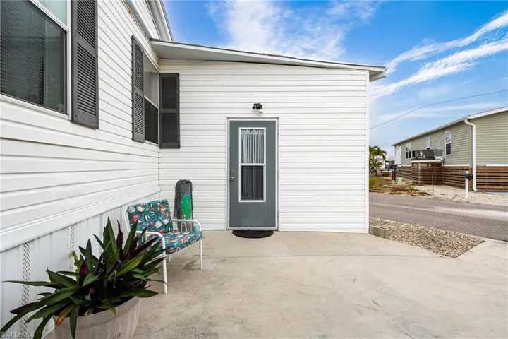 View of driveway and entry to utility room