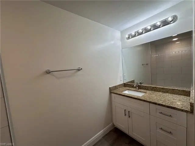 Bathroom with vanity and dark wood-style floors