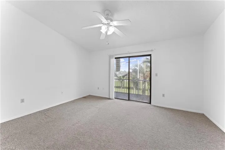 Unfurnished room with ceiling fan and carpet