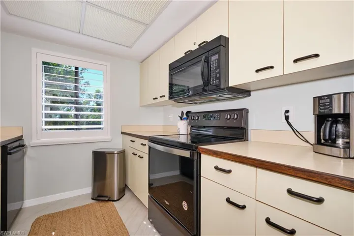 Kitchen featuring light countertops and plenty of cabinet space.