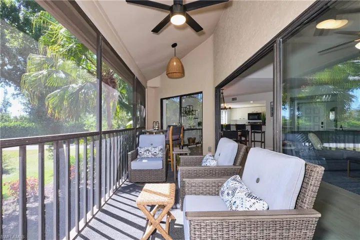 Sunroom featuring lofted ceiling and a lighted ceiling fan