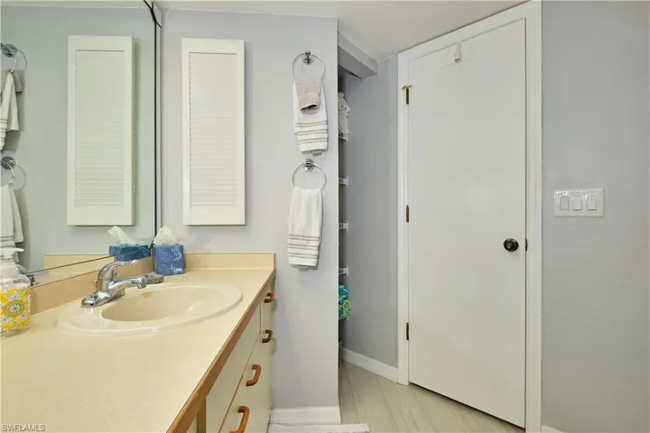 Bathroom featuring vanity and linen closet.