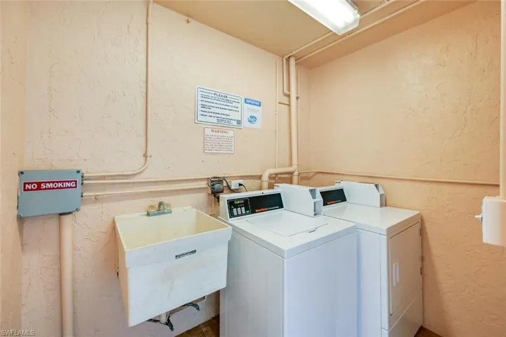 Common Laundry room with separate washer and dryer and sink
