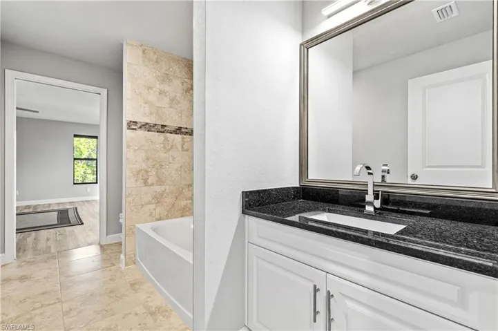 Bathroom featuring vanity and shower / bath combination
