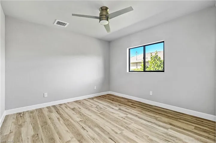 Spare room featuring light wood-type flooring and a ceiling fan