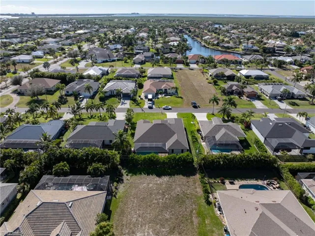 Aerial overview of property's location featuring nearby suburban area and a large body of water