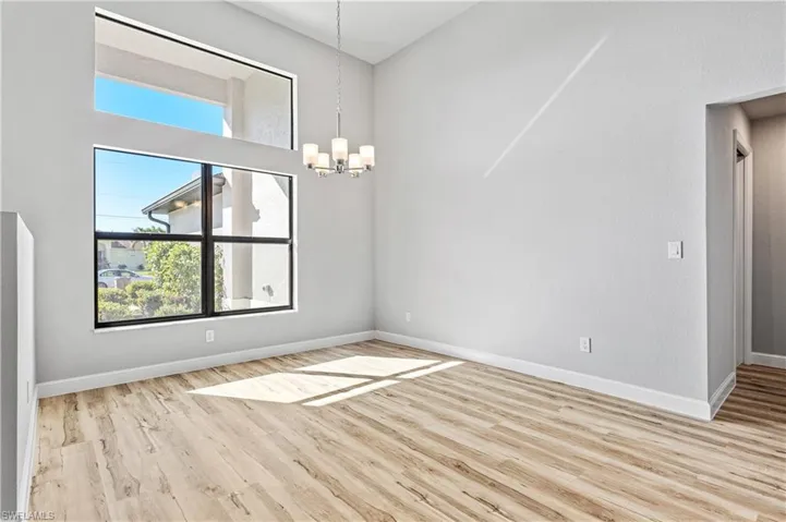 Unfurnished dining area with light wood-style floors and a chandelier