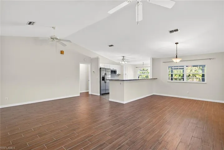 Unfurnished living room with wood finish floors