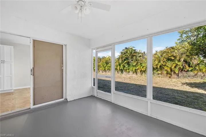 Unfurnished sunroom with ceiling fan