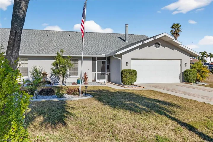 Ranch-style house featuring stucco siding, an attached garage, concrete driveway, and a front yard
