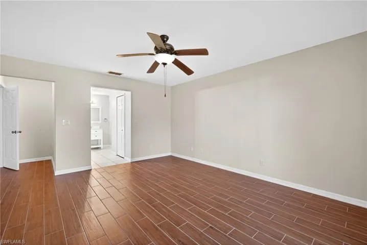 Spare room featuring ceiling fan and wood finish floors
