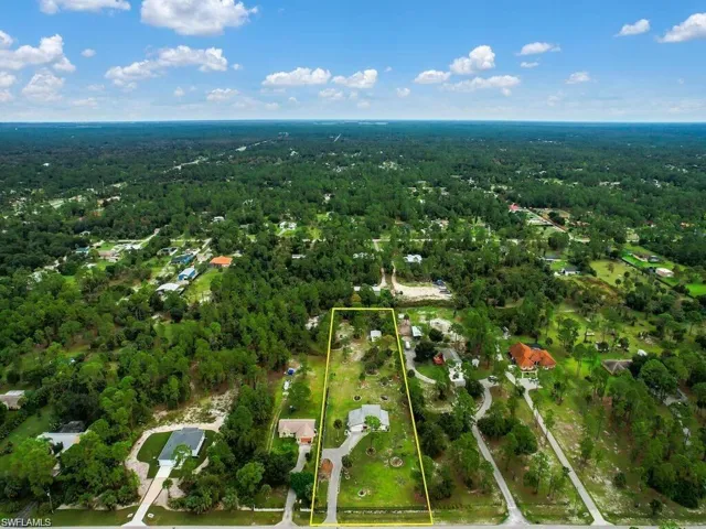 View of property location with a heavily wooded area and property boundaries highlighted